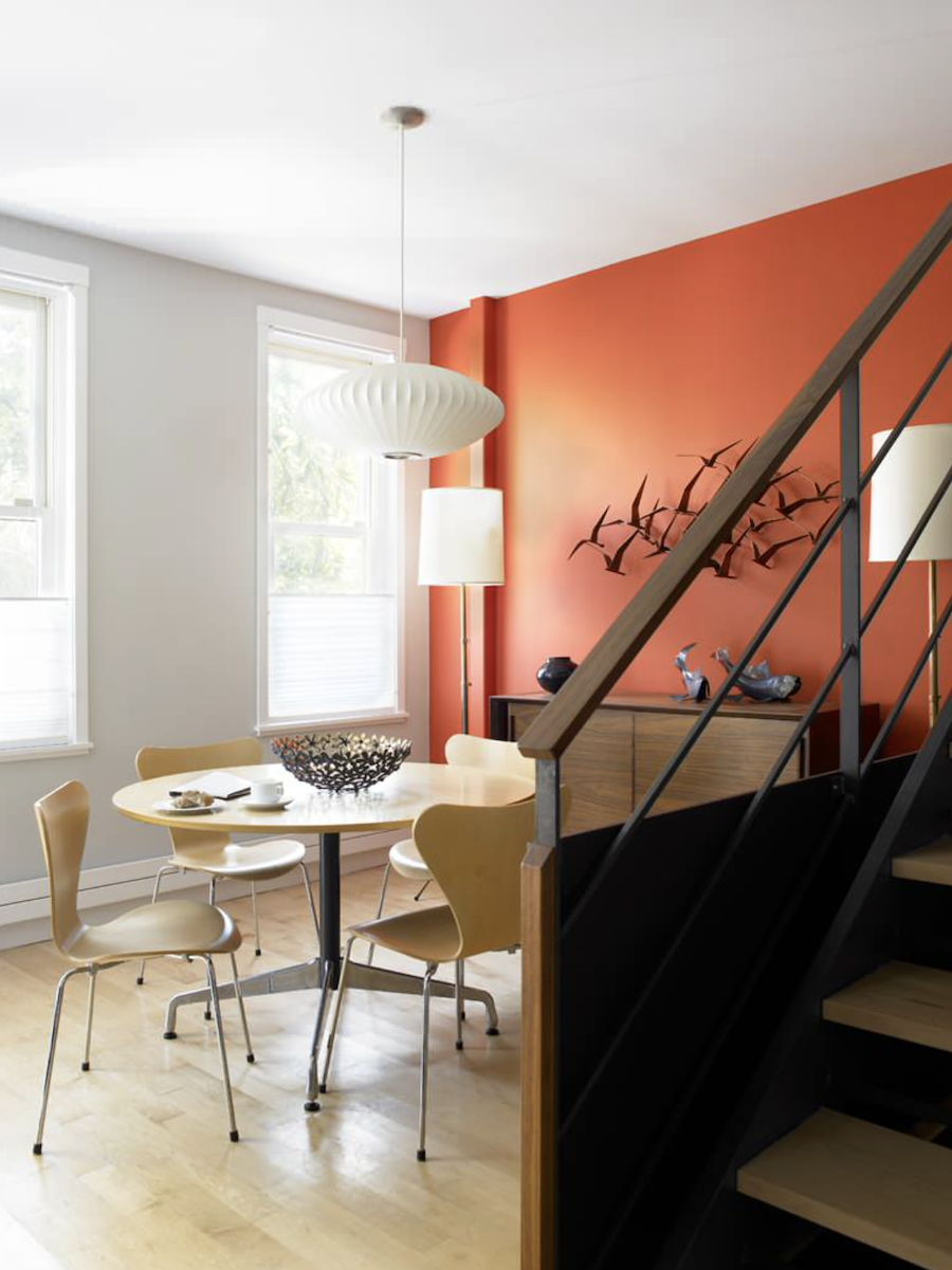 Dining room with rust accent wall.