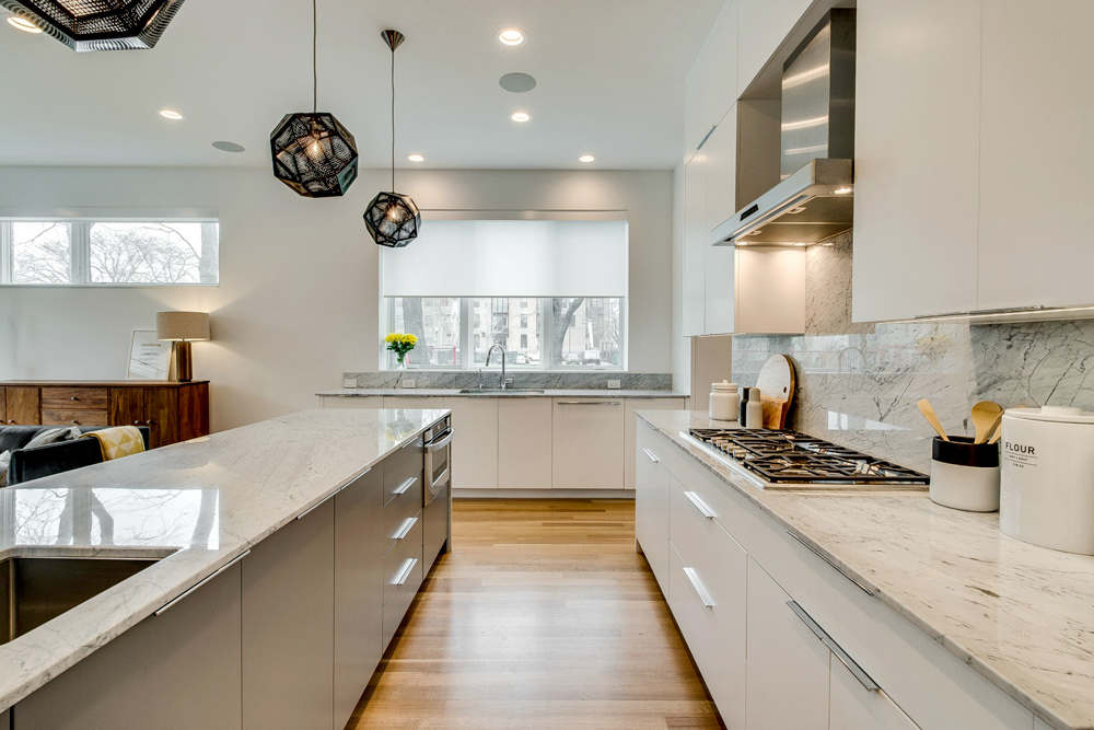 white kitchen with black pendant lights and white screen shades in Roseville CA