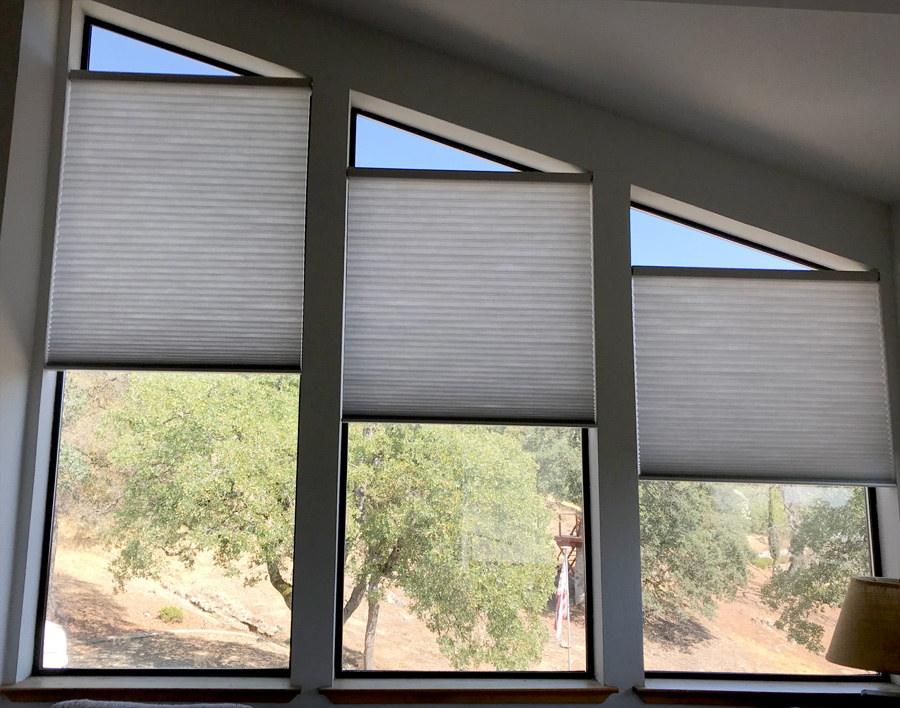 angled windows with gray energy efficient honeycomb shades