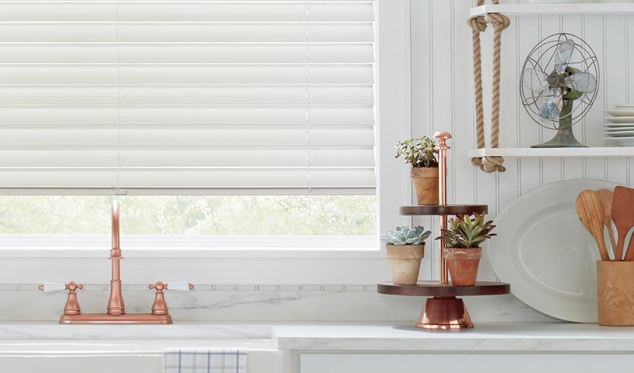 detail of rose gold kitchen accents and white wood grain blinds in white Folsom, CA kitchen