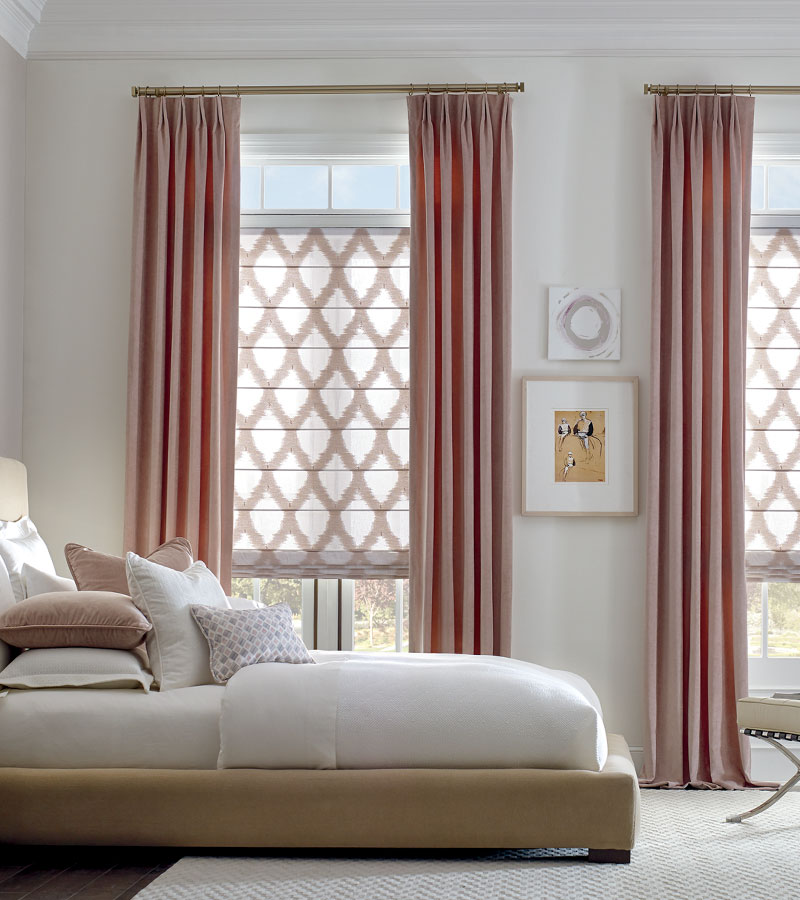 Blush pink drapery panels with gold rod and patterned fabric roman shades Roseville, CA