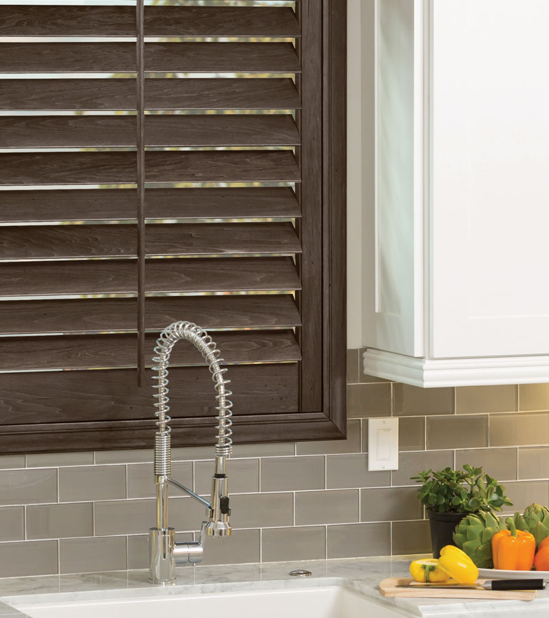 kitchen window with hardwood shutters behind sink in Lincoln, CA