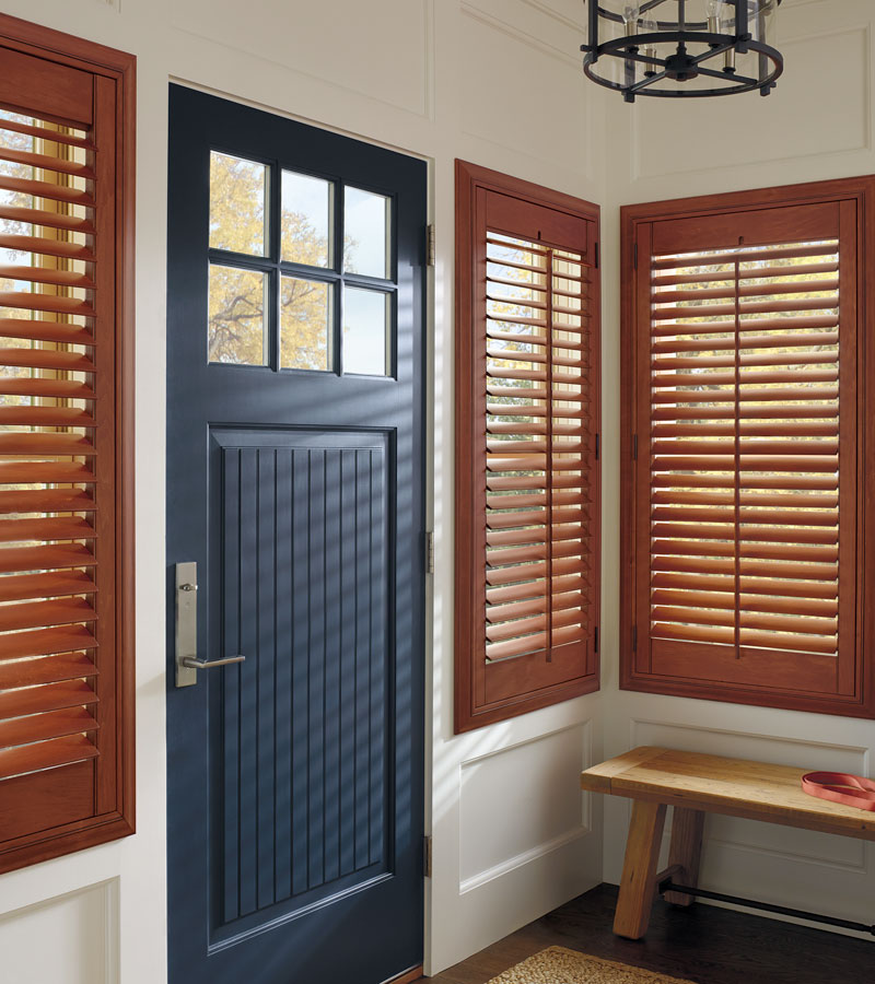 entryway windows covered with custom cherry stained wood shutters in el Dorado Hills, CA