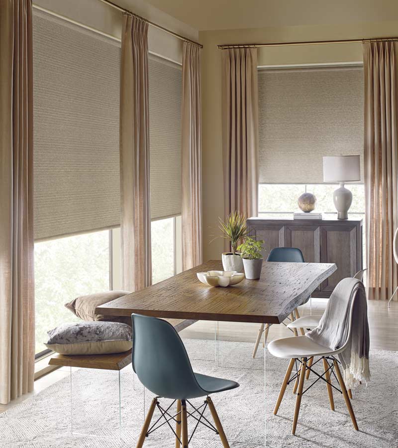 design studio southwest style dining room with roller shades and drapery