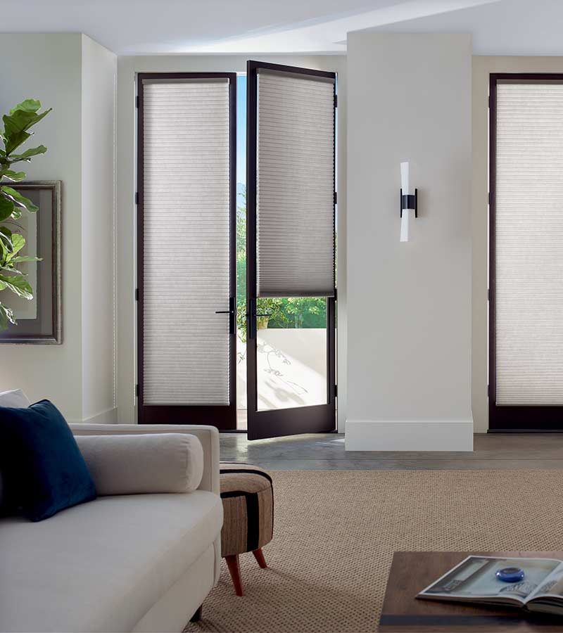 https://calwindowfashions.com/wp-content/uploads/2022/03/glass-doors-gray-honeycomb-shades-hunter-douglas-patio-door-shades-california-window-fashions.jpg