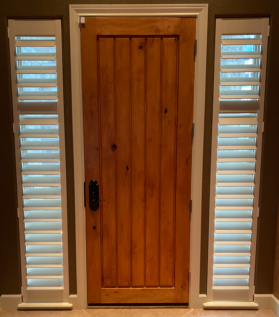 plantation shutters on narrow sidelights next to front door 