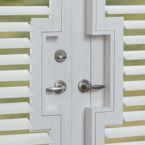 rectangular door handle cut-outs on white shutters for french doors