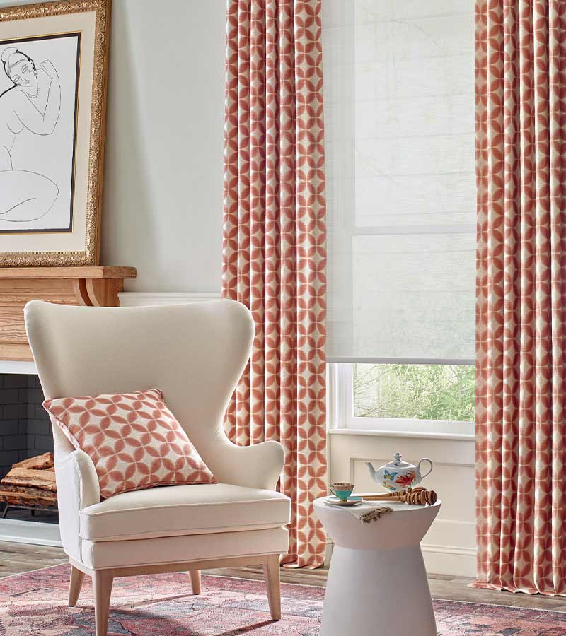 red and cream pattern on curtains with dual opacity gray roller shades in roseville, ca