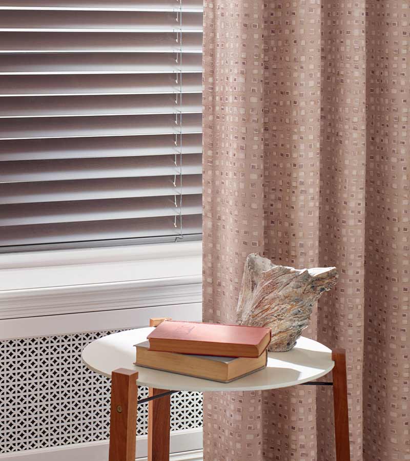 soft blush drapes with square patterns with rose gold aluminum blinds