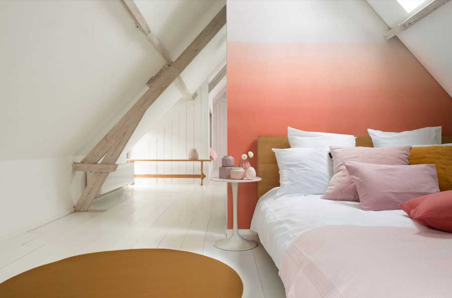 Coral ombre wall in neutral bedroom