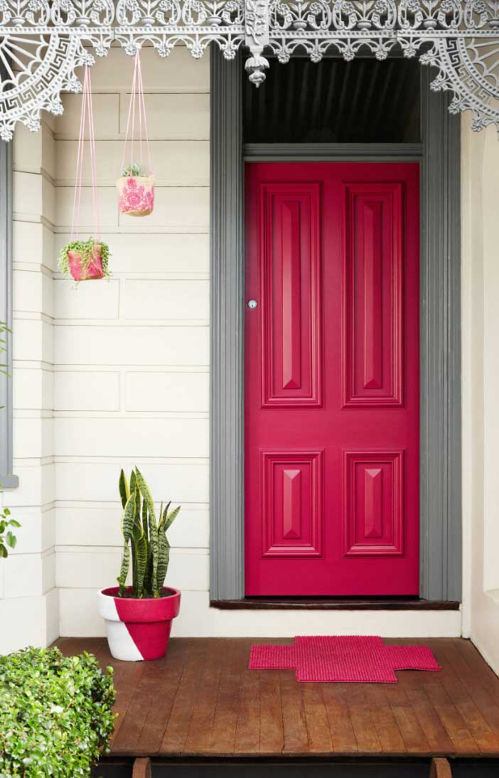 Hot pink front door on white house