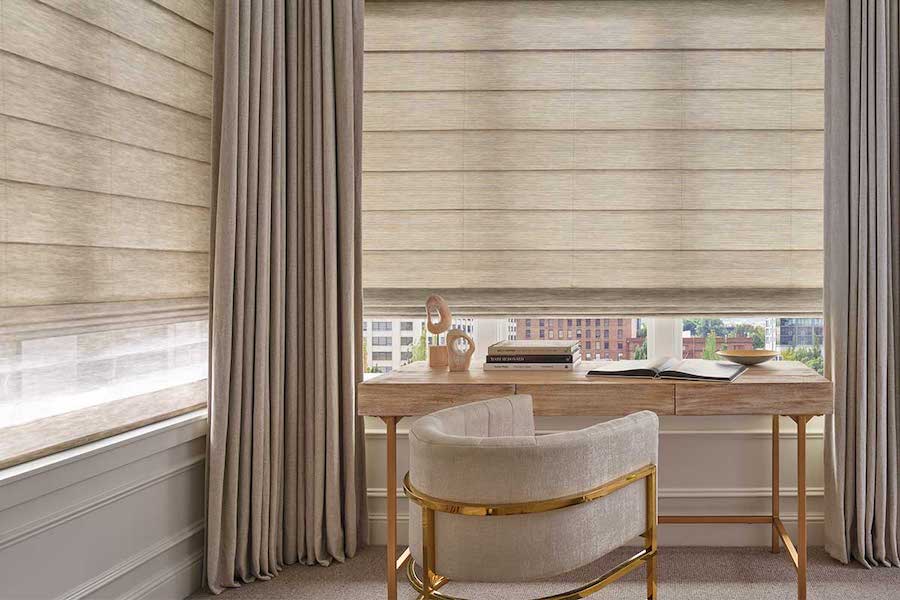 Roman shades paired with draperies