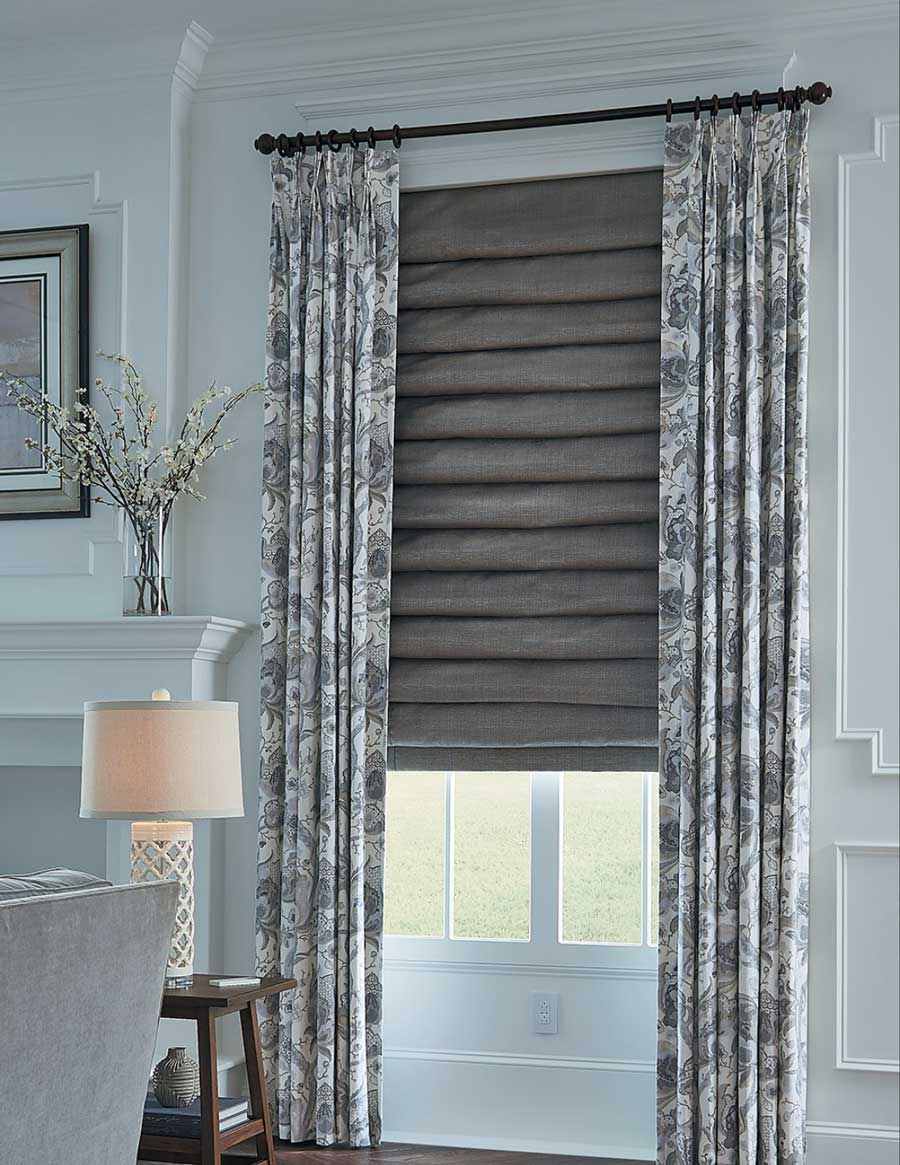 gray roman shades as layered fabrics with drapery panels in Roseville CA home