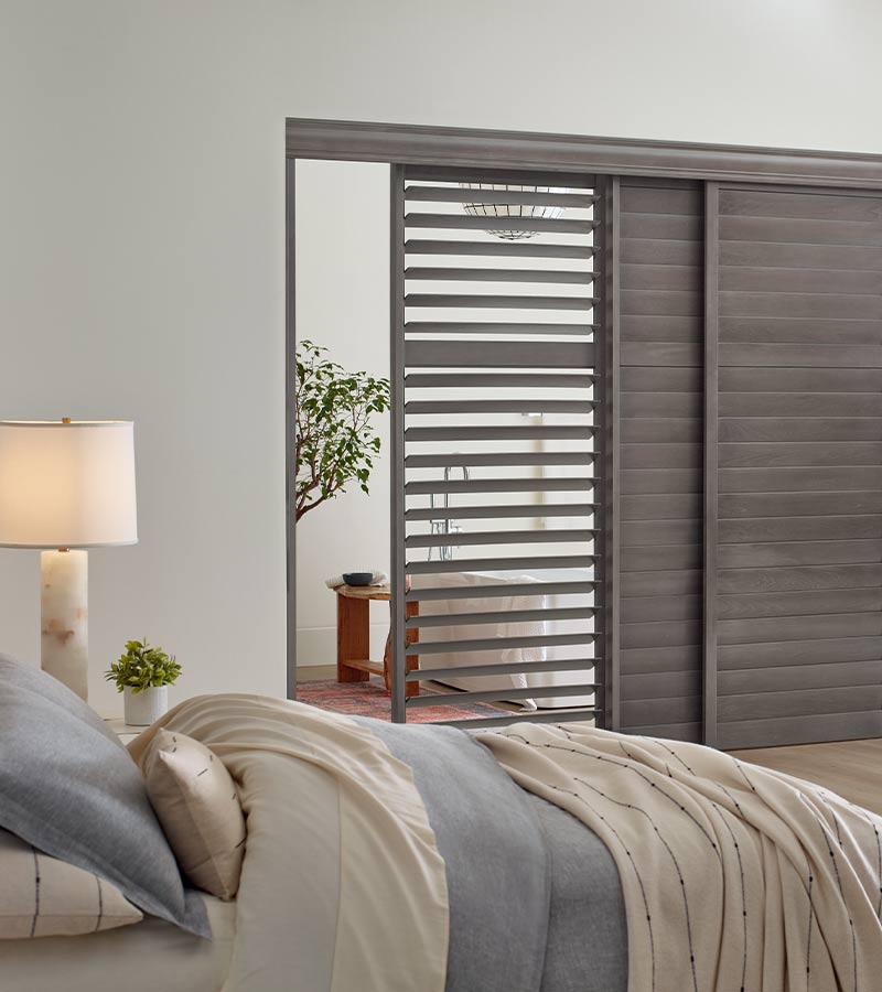 gray wood interior window shutters on sliding glass door for guest bedroom