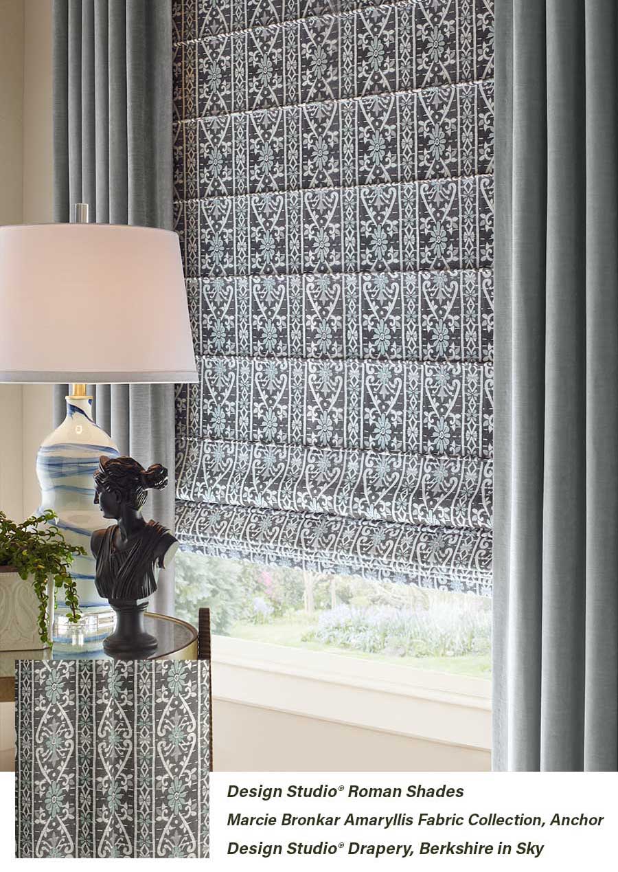 living area room with moody and patterened design studio roman shades