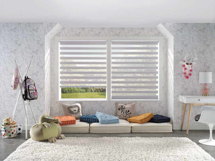 cushions and pillows in front of white window coverings