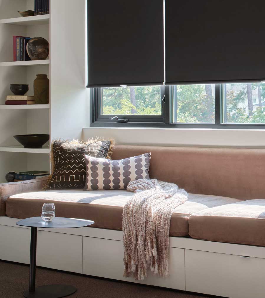 designer roller shades with blackout fabric in casement window