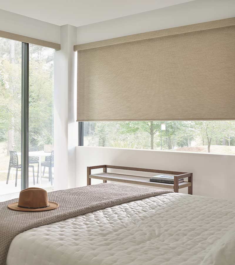 cream designer roller shades in bedroom