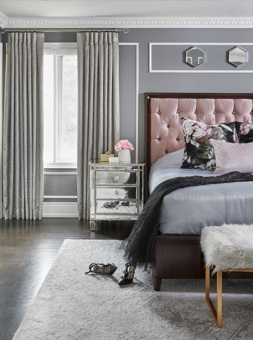 gray walls with pop of dusty rose headboard in bedroom