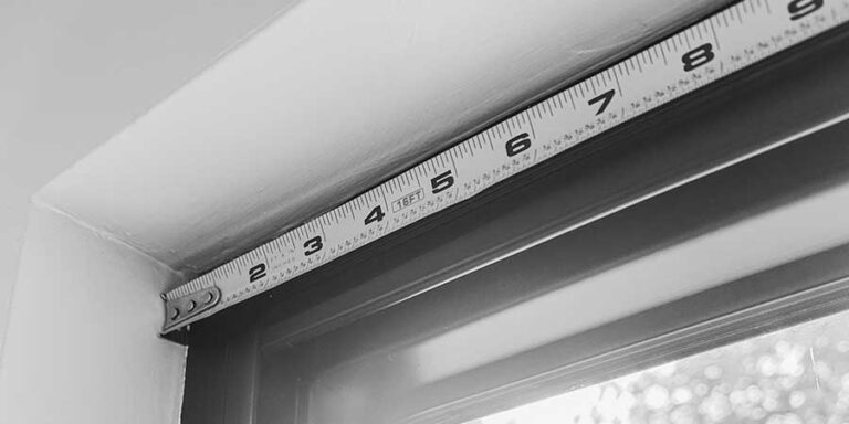measuring window with tape measure