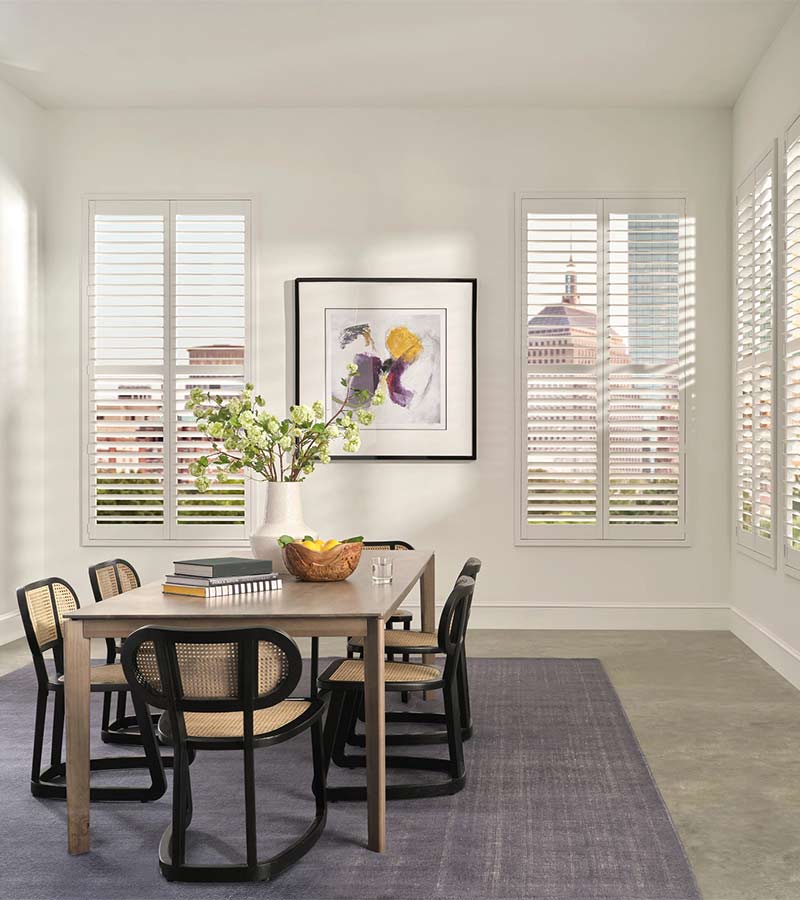 palm-beach-vinyl-bi-fold-dining-room-shutters-california-window-fashions white palm beach vinyl shutters along wall in dining room