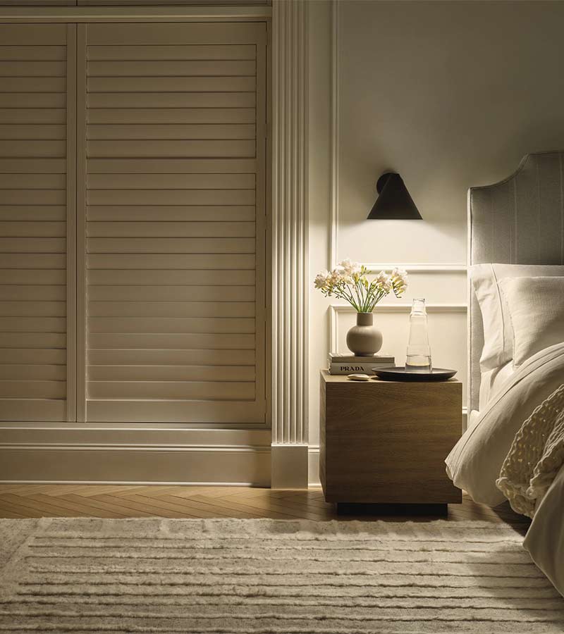 palm-beach-vinyl-shutters-room-darkening-bedroom-california-window-fashions dark room with palm beach vinyl shutters in bedroom
