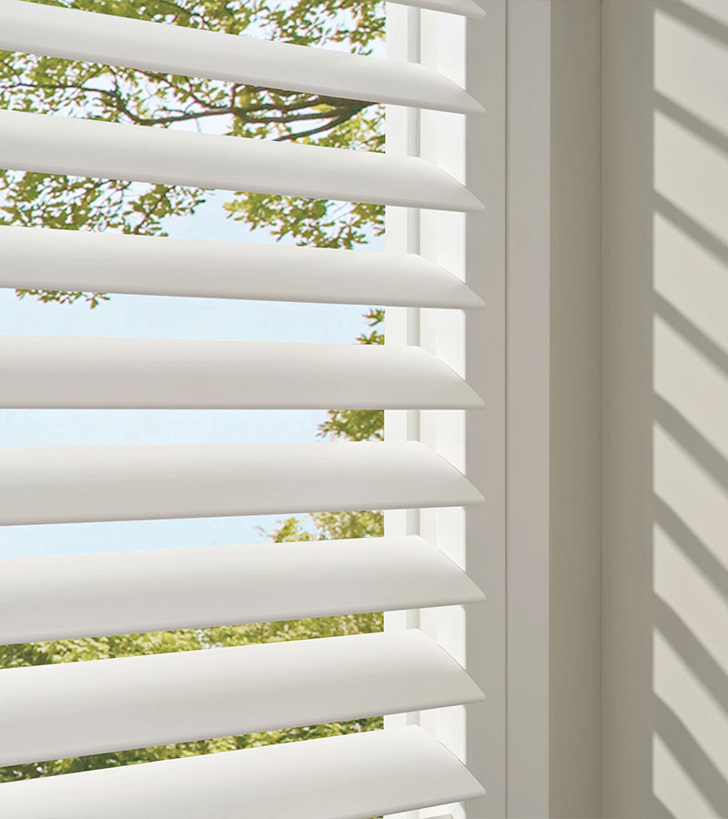 palm-beach-vinyl-shutters-standard-hinge-california-window-fashions close up of white vinyl shutters on window open