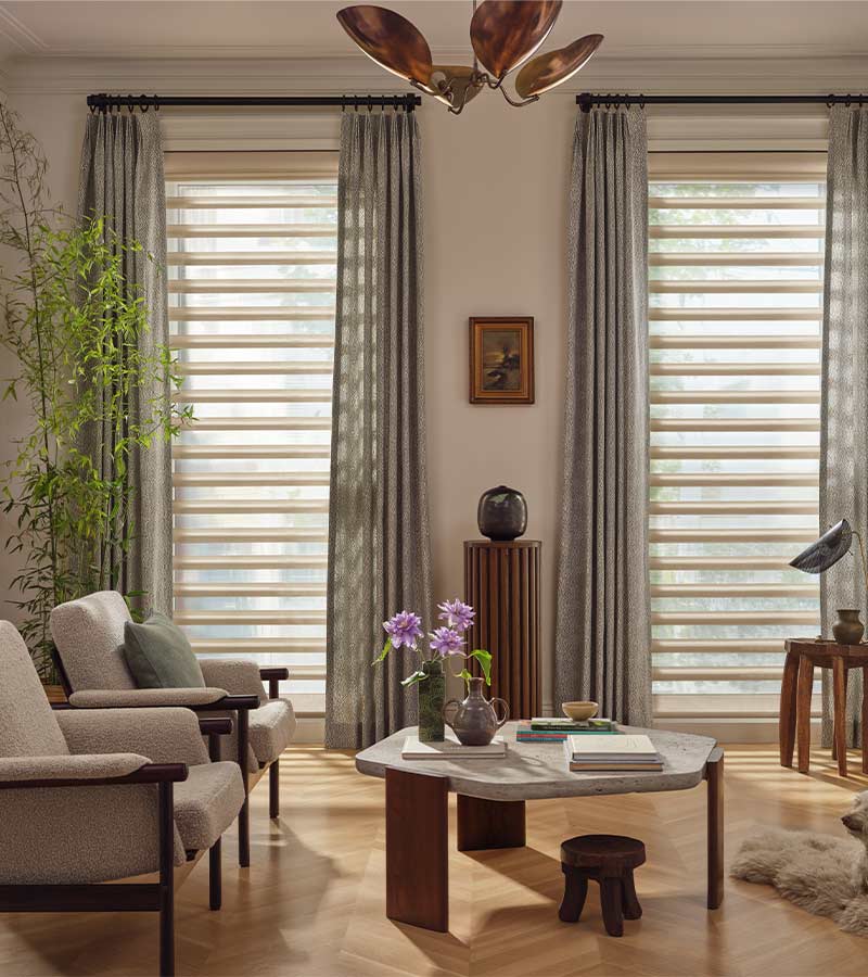 pirouette-window-treatments-living-room-drapery-layered-over-shades-hunter-douglas-california-window-fashions Pirouette window shades with curtains in living room during daylight